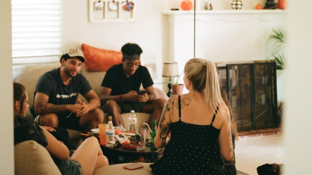 young people having a party at a living room