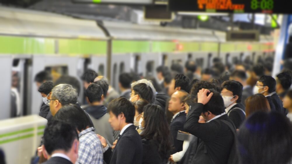 People wait for a train