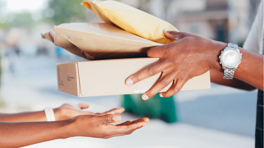 a man passes parcels to a woman