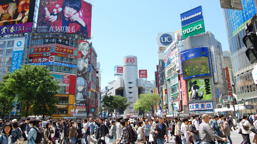 people walk at crossroad in Shibuya