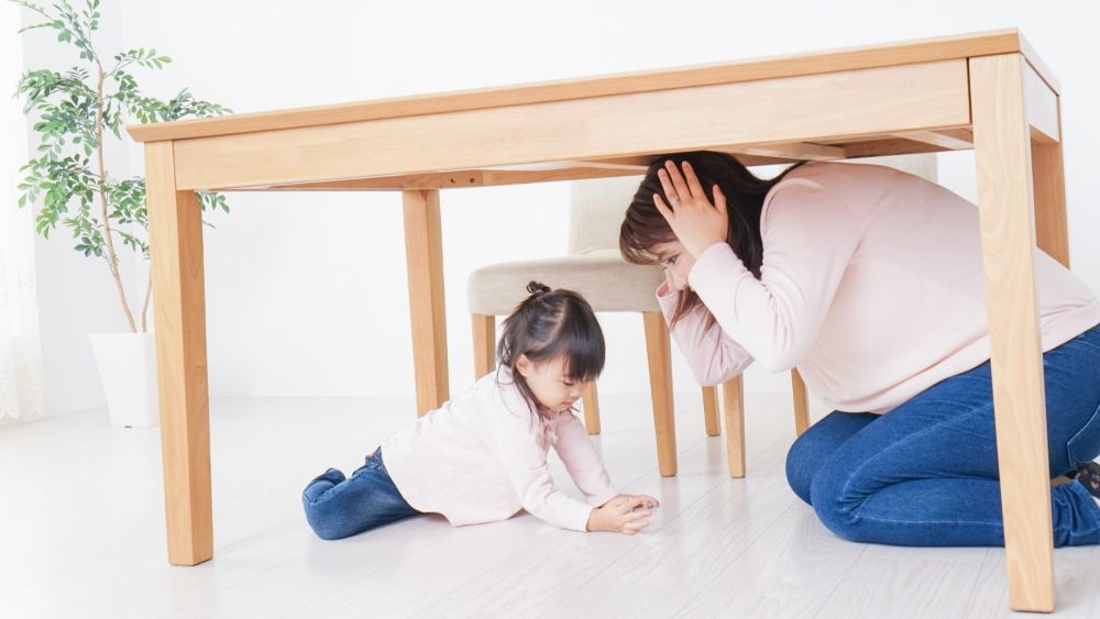 a family hide under the table