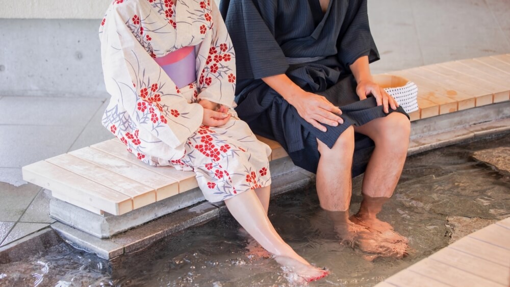 a couple enjoy ashiyu, a foot bath