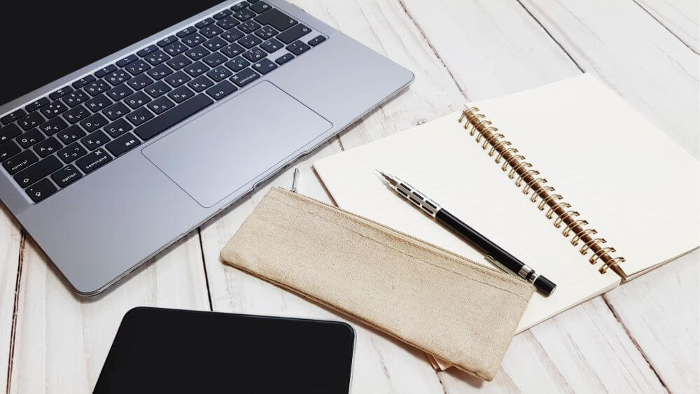 Pc, note, smartphone and a pen on the table