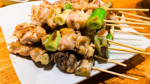 grilled chickens and leeks are skewered