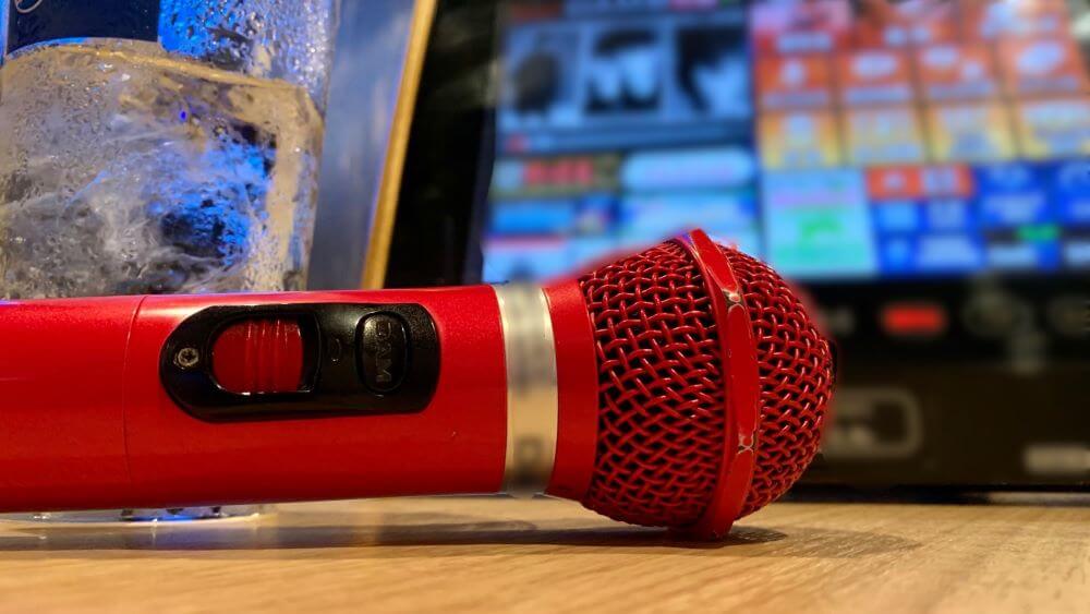 karaoke microphone and a remote controller on a table